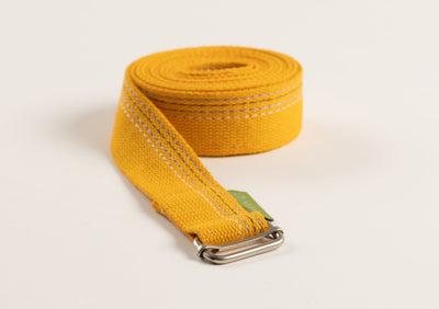 A yellow yoga strap with a buckle.
